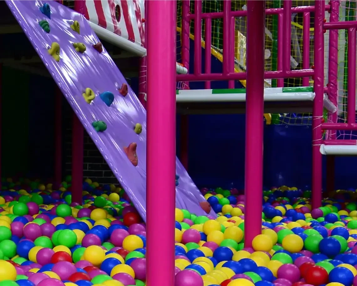 Many colorful plastic balls in a kids' ballpit at a playground